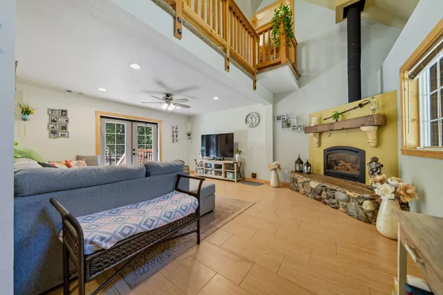 a living room with furniture a fireplace and a flat screen tv