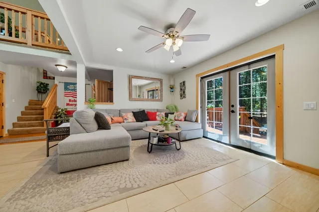 a living room with furniture and large windows