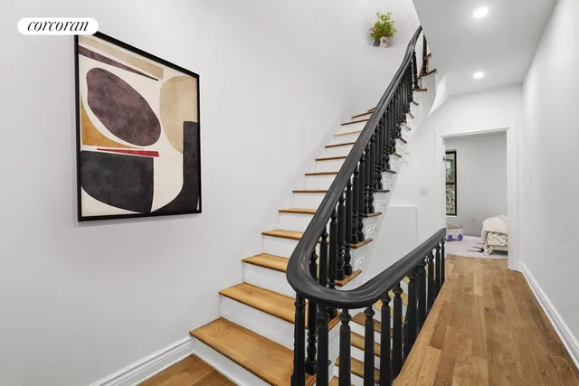 a view of entryway and hall with wooden floor