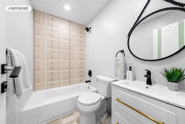 a bedroom with a bed a mirror and dresser