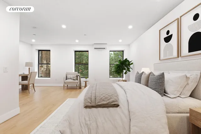 a spacious bedroom with a large bed and furniture