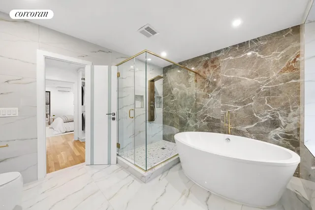 a bathroom with a bathtub and shower
