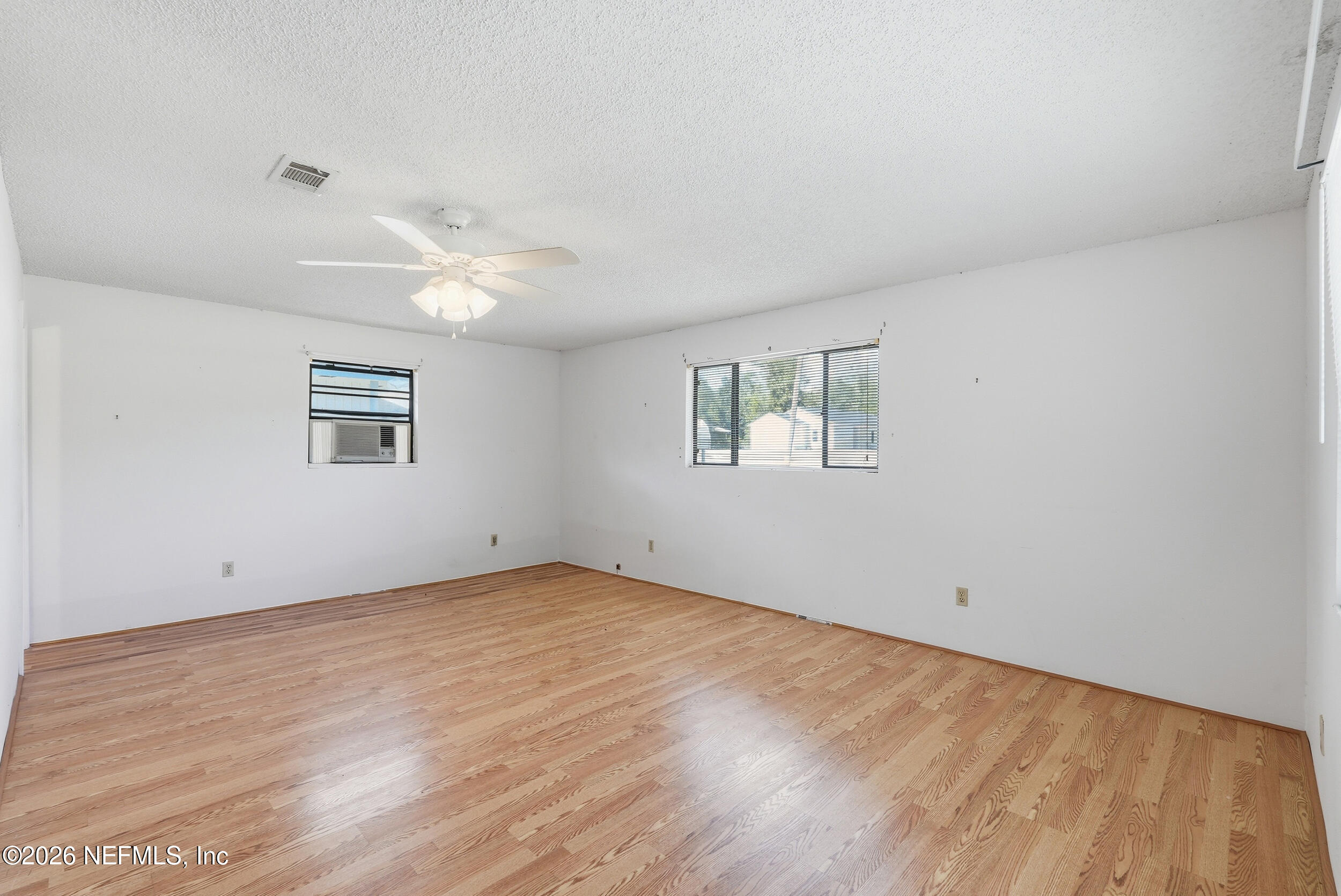 7593 Silver Sands Road Keystone Heights, FL 32656 - Photo 20 of 36 wooden floor in an empty room with a window