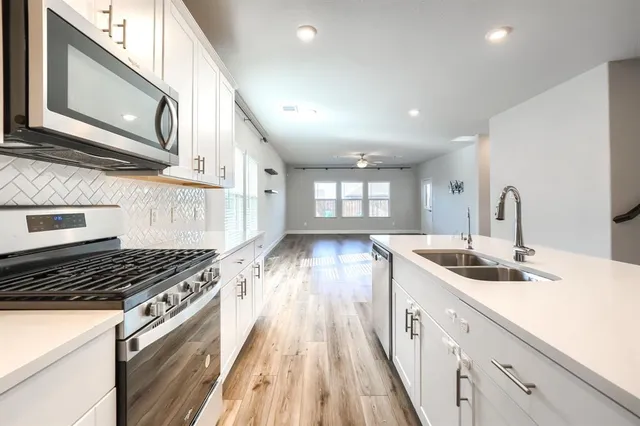 a kitchen with granite countertop a stove and a sink