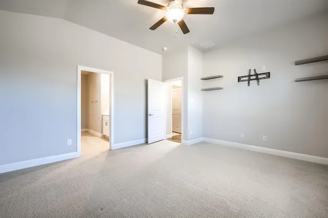 an empty room with closet and windows