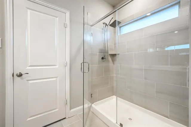 a bathroom with a glass shower door