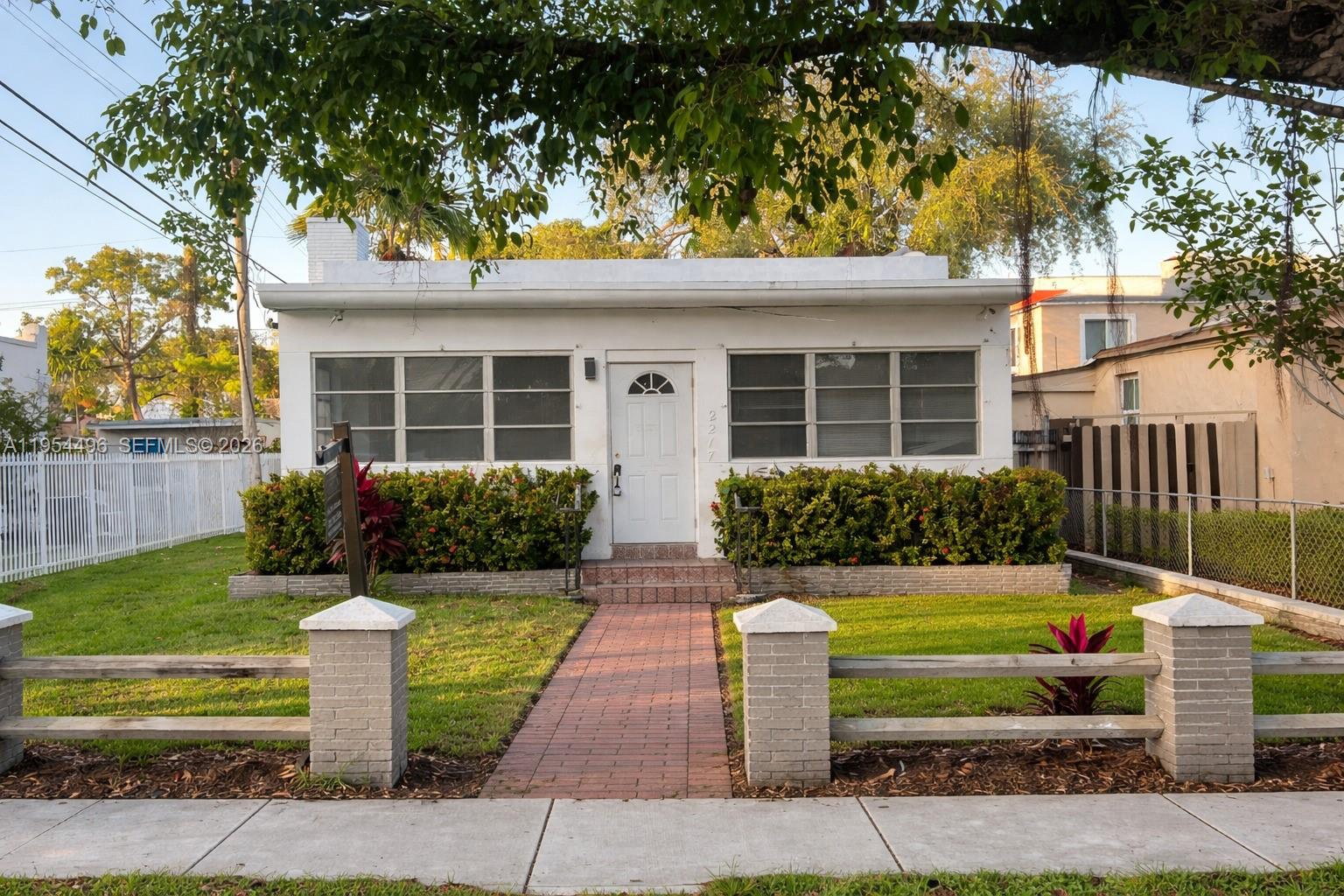2217 Southwest 11th Street Miami, FL 33135 - Photo 1 of 13 a front view of a house with a yard