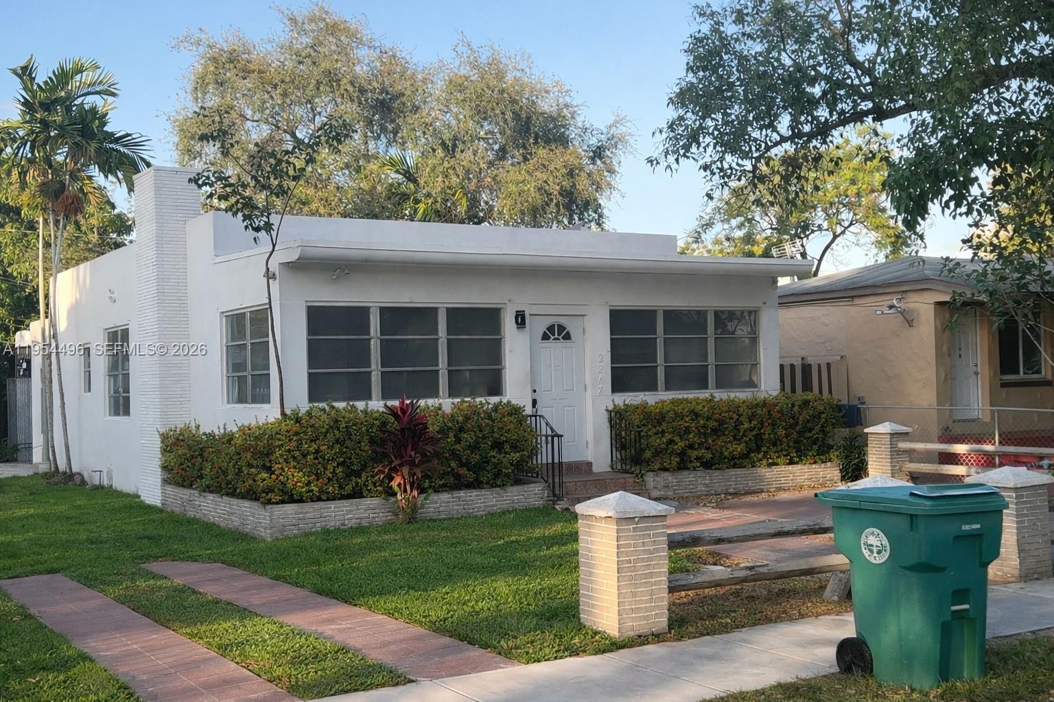 2217 Southwest 11th Street Miami, FL 33135 - Photo 11 of 13 a front view of a house with garden and porch