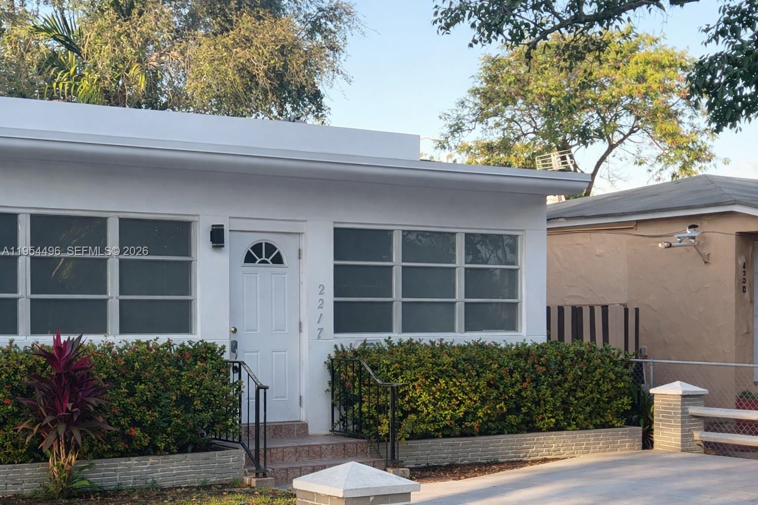 2217 Southwest 11th Street Miami, FL 33135 - Photo 12 of 13 a front view of a house with garden