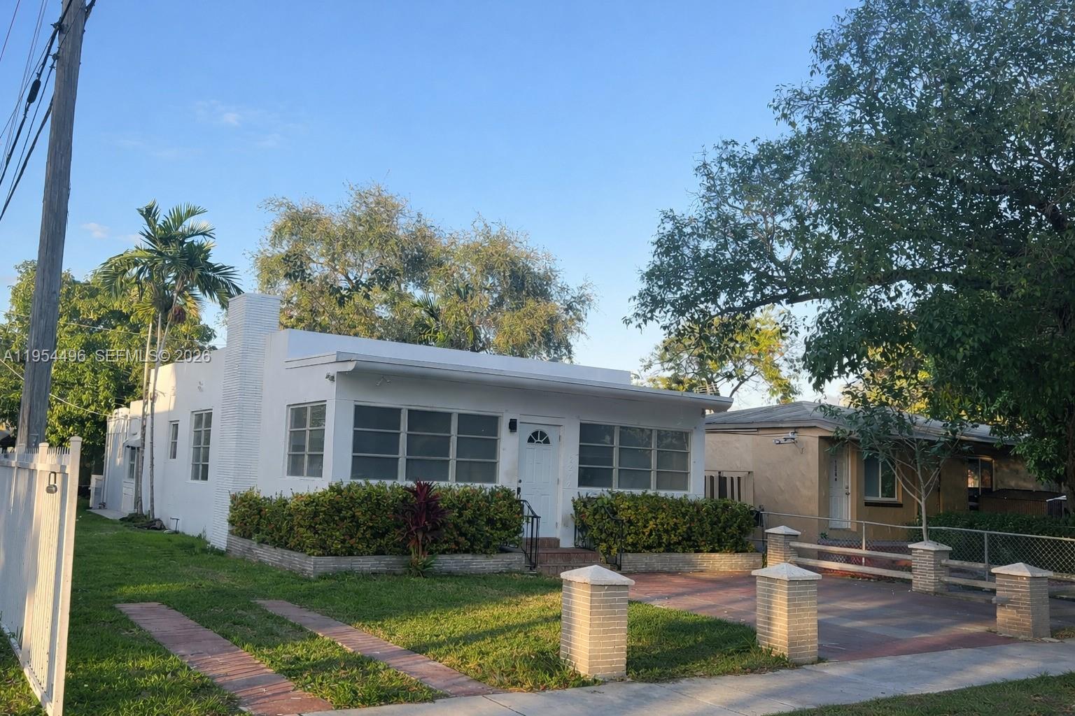 2217 Southwest 11th Street Miami, FL 33135 - Photo 13 of 13 a front view of a house with a yard and potted plants