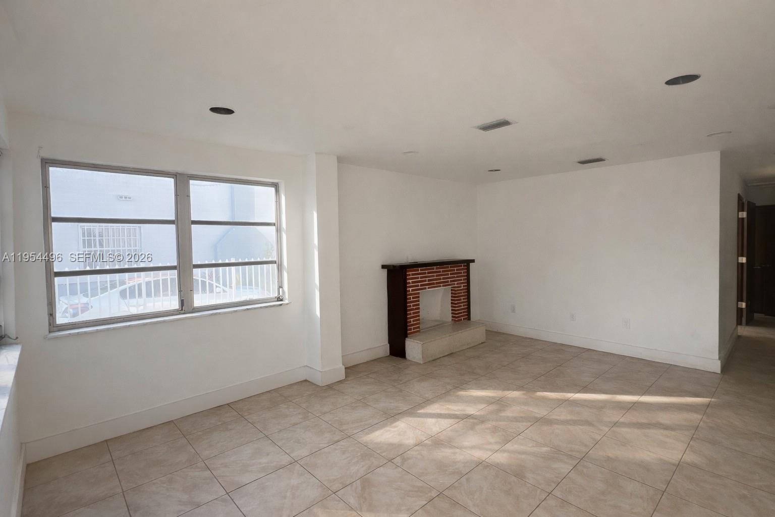 2217 Southwest 11th Street Miami, FL 33135 - Photo 2 of 13 an empty room with windows