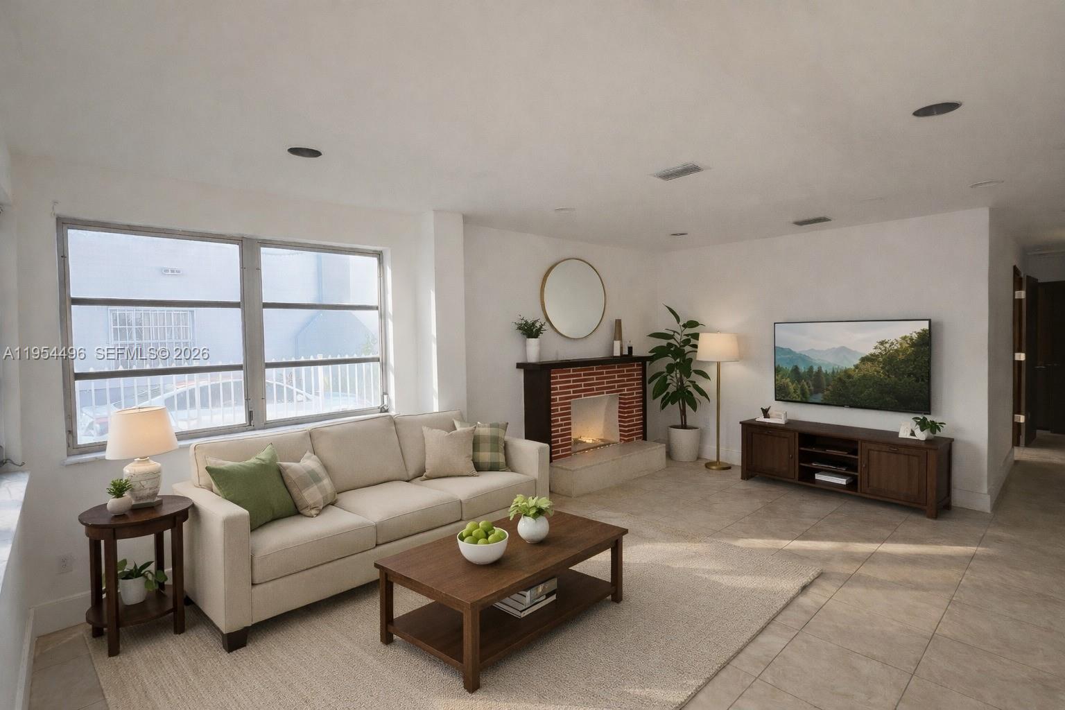 2217 Southwest 11th Street Miami, FL 33135 - Photo 3 of 13 a living room with furniture a flat screen tv and a fireplace