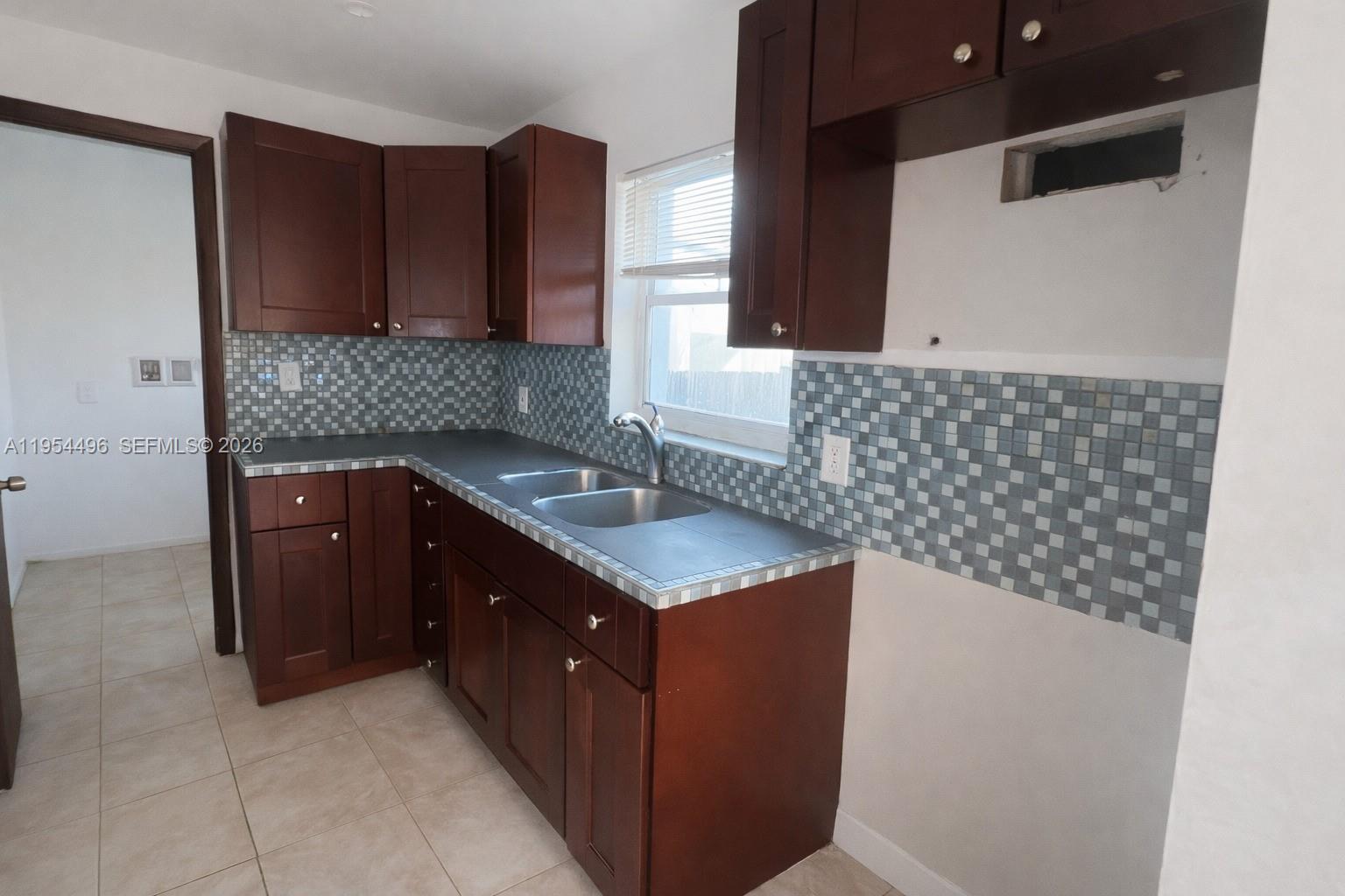 2217 Southwest 11th Street Miami, FL 33135 - Photo 8 of 13 a kitchen with a sink and cabinets