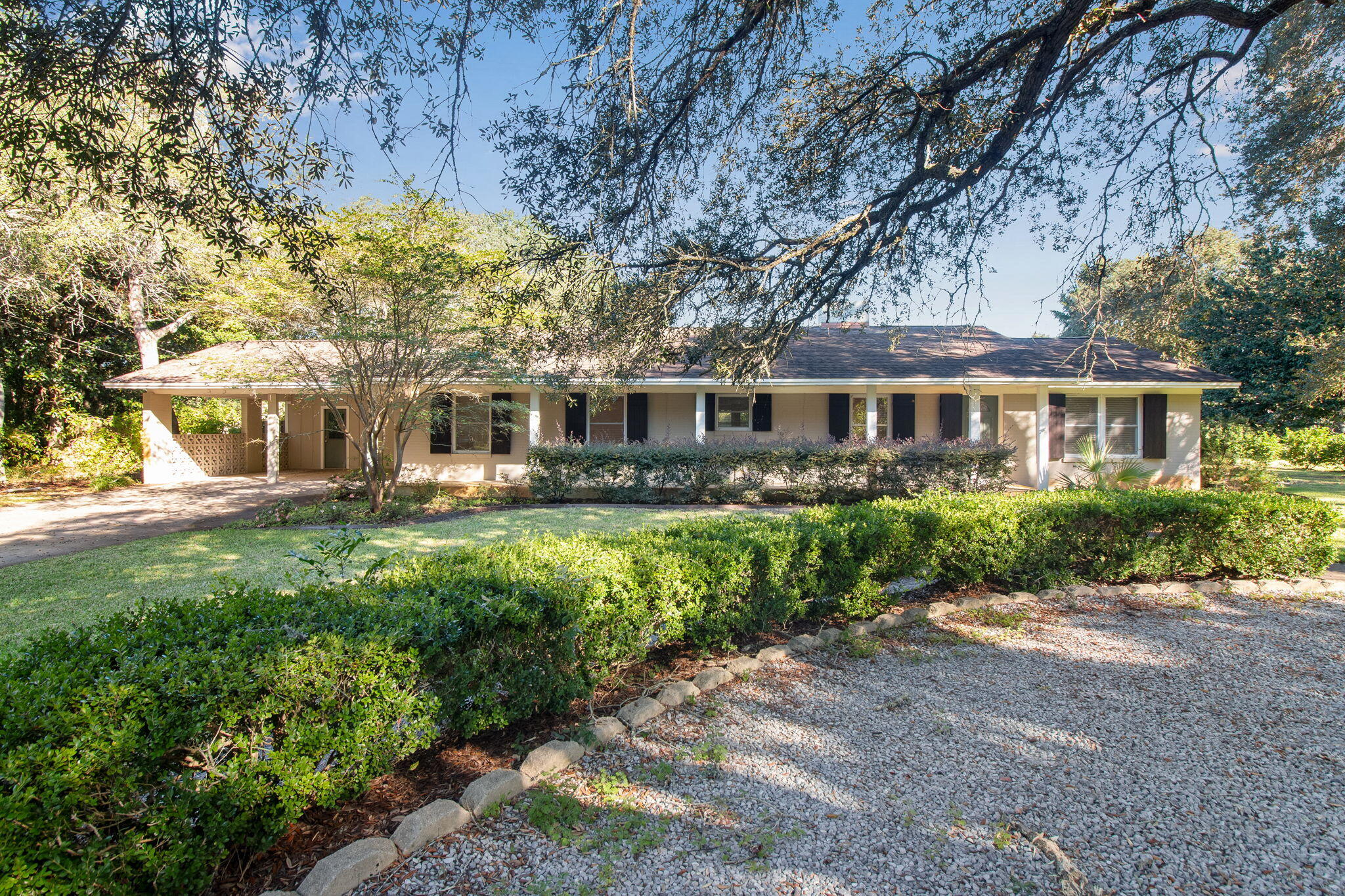 a front view of a house with a yard and lake view