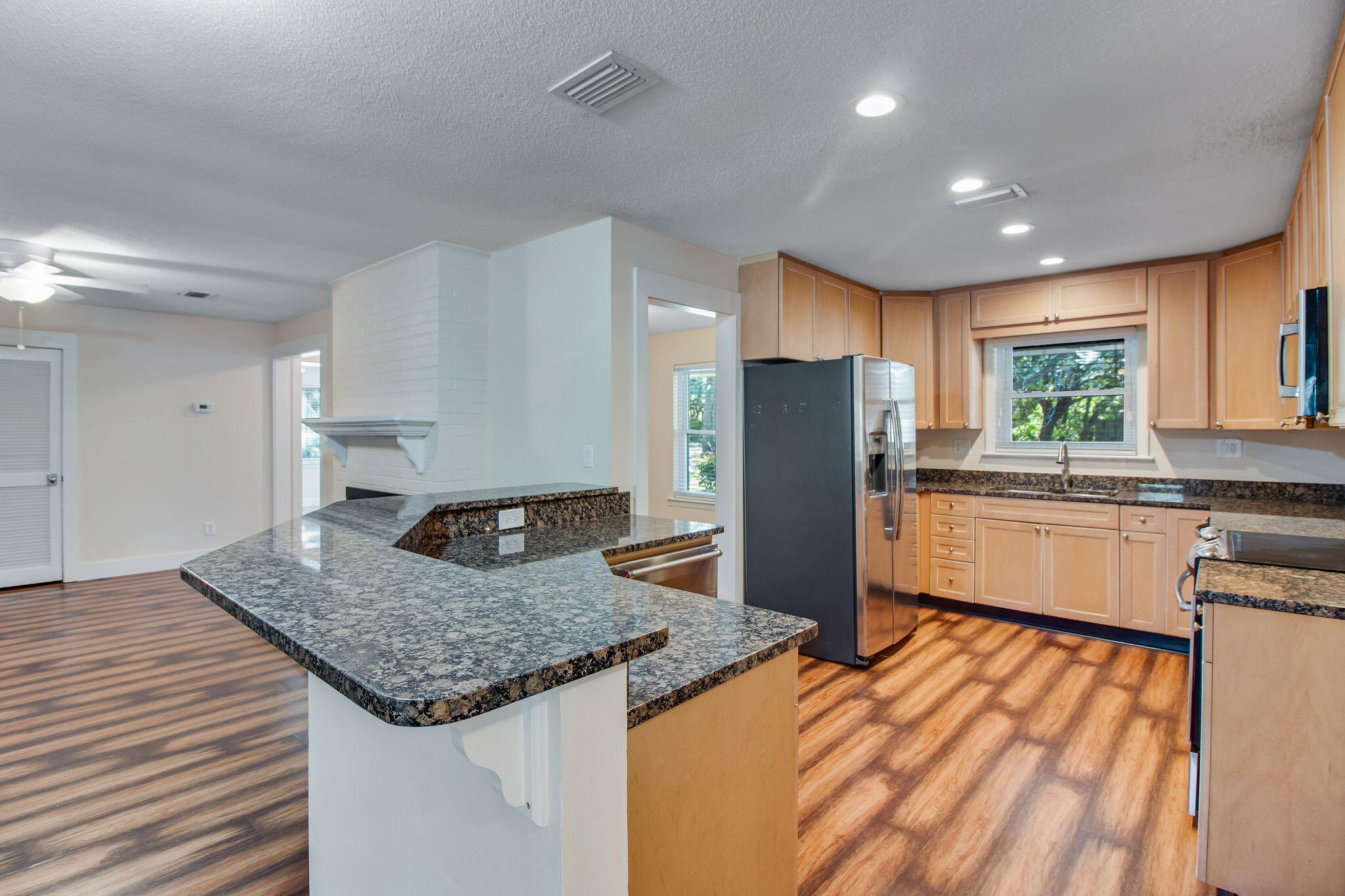 701 Planet Drive Destin, FL 32541 - Photo 11 of 25 a kitchen with stainless steel appliances granite countertop refrigerator sink and cabinets