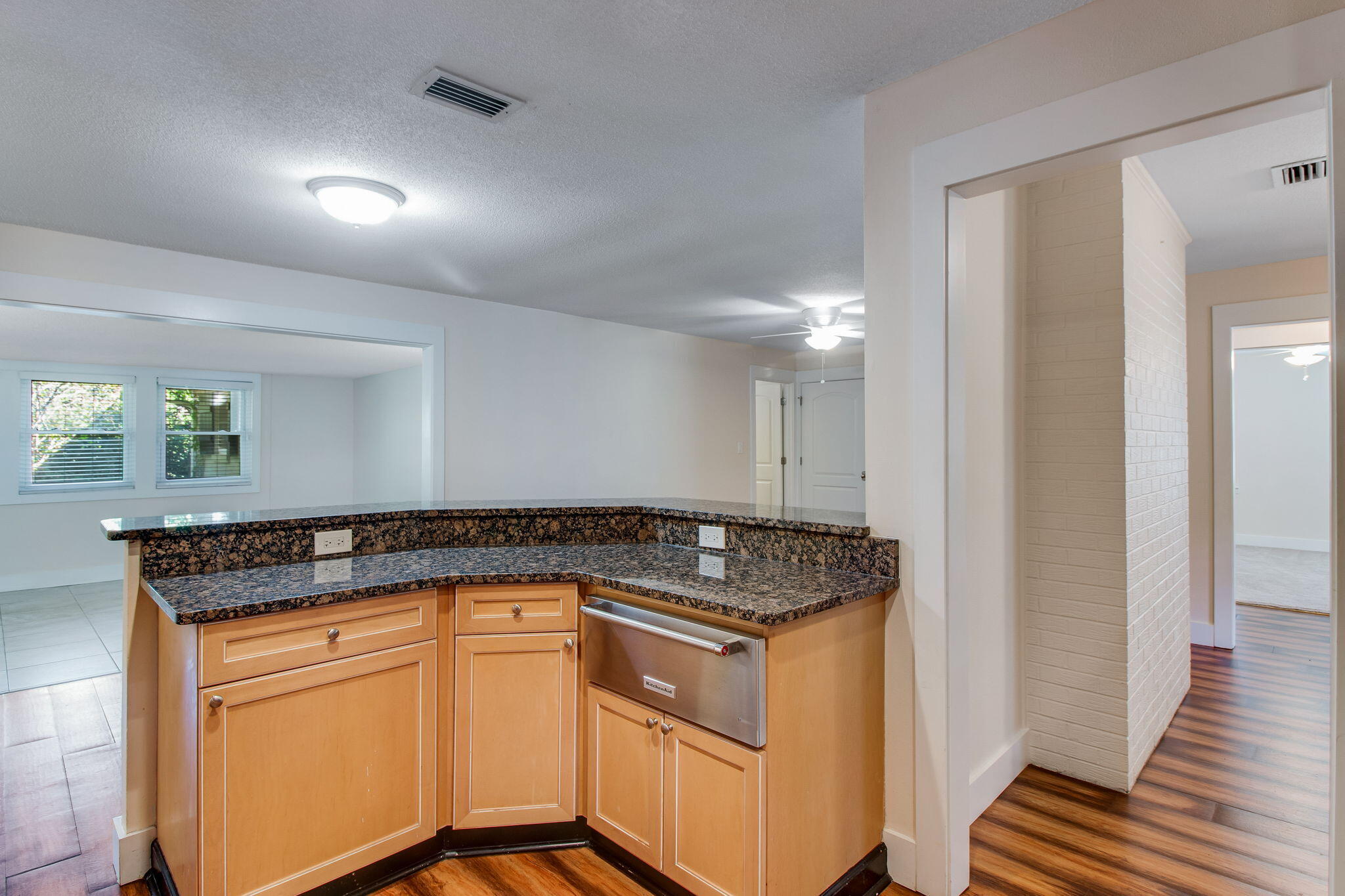 701 Planet Drive Destin, FL 32541 - Photo 14 of 25 a kitchen with granite countertop a sink and cabinets