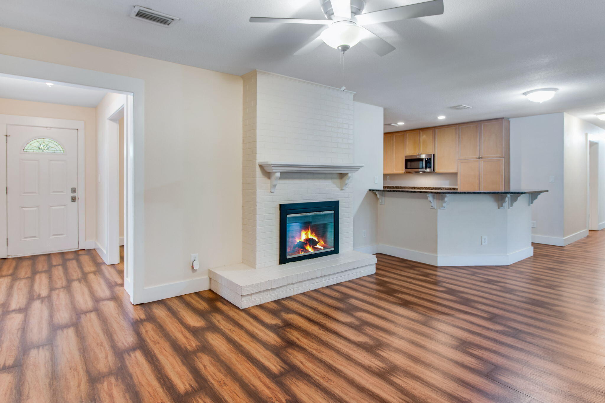 701 Planet Drive Destin, FL 32541 - Photo 7 of 25 a view of a kitchen and an empty room with wooden floor