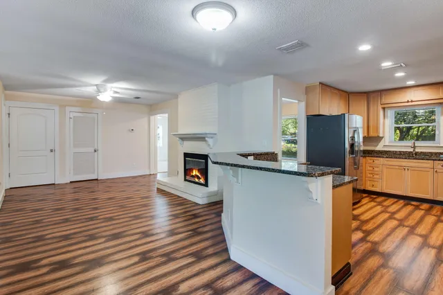 a view of a kitchen with cabinets and wooden floor