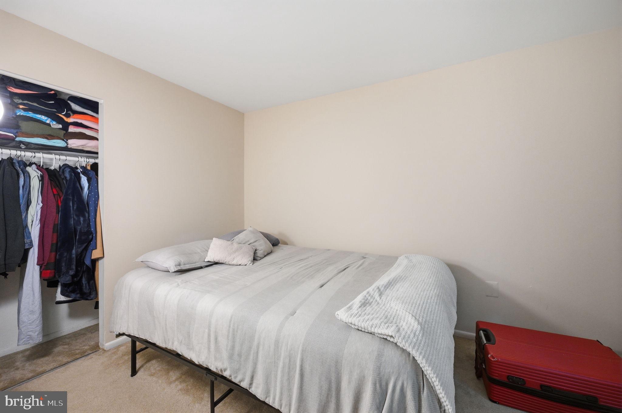 3366 Woodburn Road, Unit 23 Annandale, VA 22003 - Photo 13 of 16 a bedroom with a bed and a closet