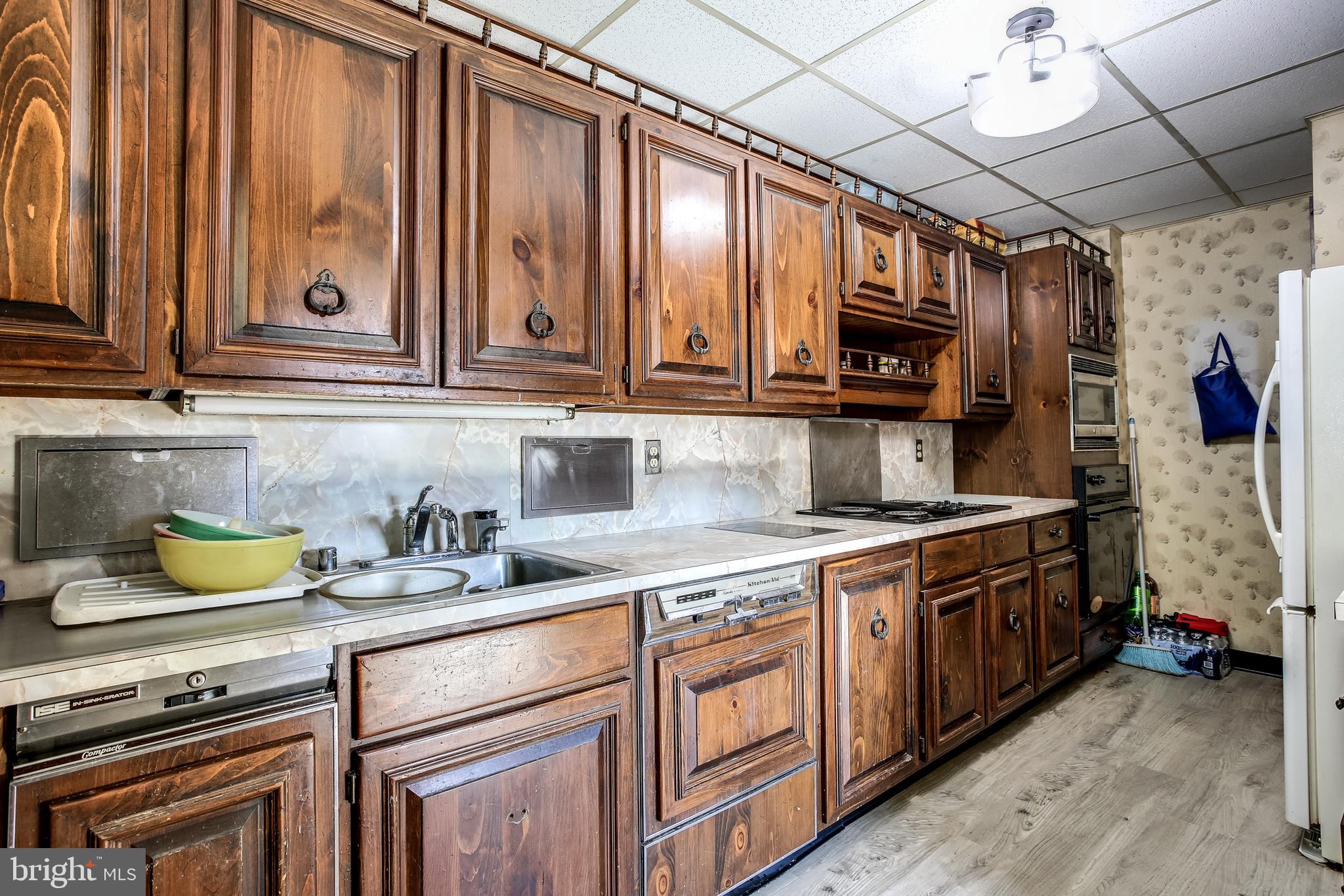 2149 Pitney Road Baltimore, MD 21234 - Photo 7 of 20 a kitchen with stainless steel appliances granite countertop a sink a stove and wooden cabinets
