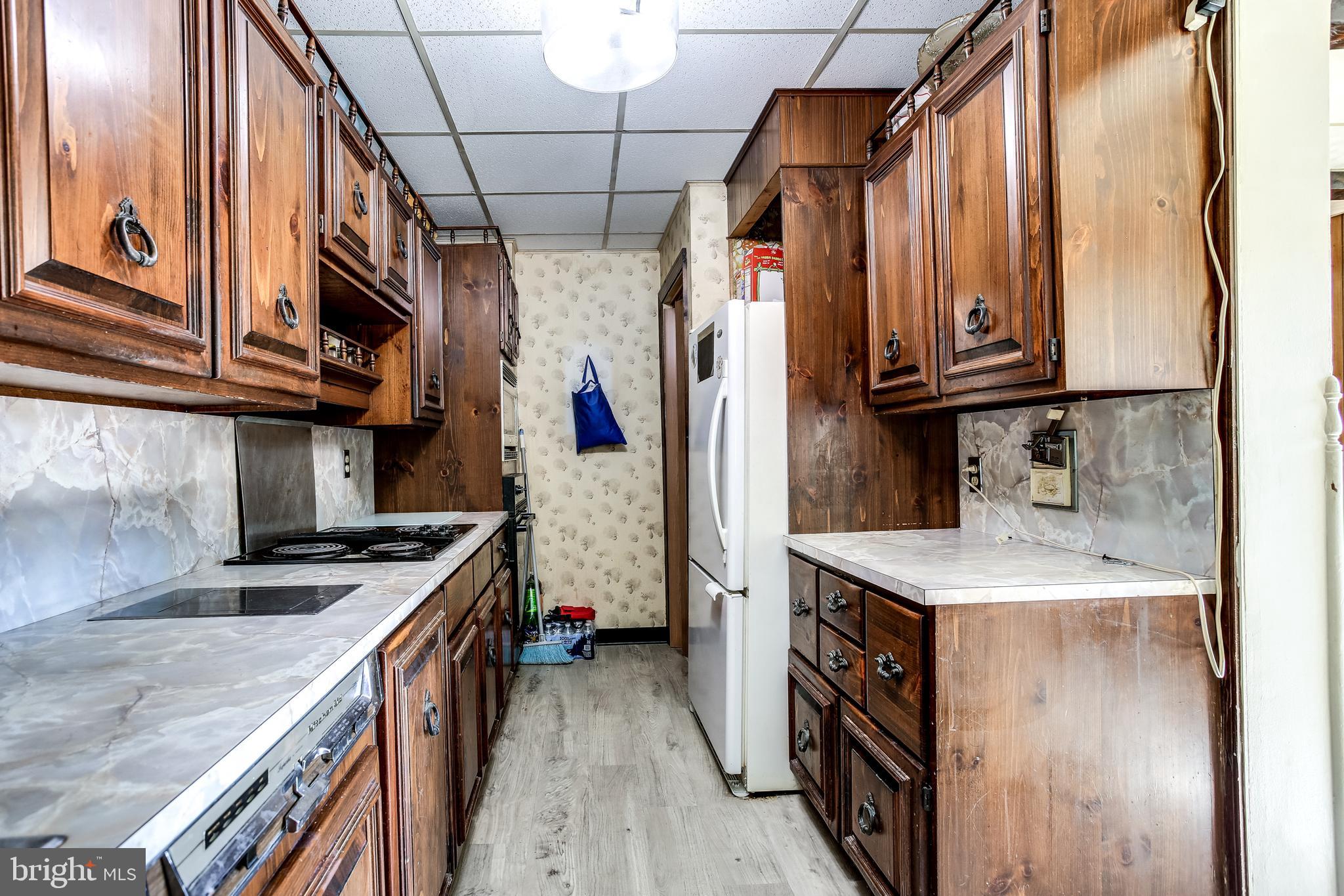 2149 Pitney Road Baltimore, MD 21234 - Photo 8 of 20 a kitchen that has a sink a stove and a wooden floors