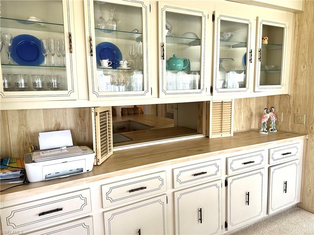 26212 Colony Road Bonita Springs, FL 34135 - Photo 17 of 34 Dining area cabinets featuring pass-through to kitchen.