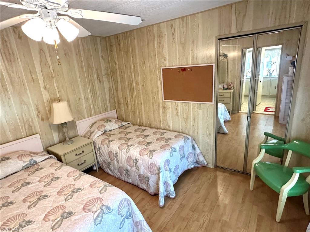 26212 Colony Road Bonita Springs, FL 34135 - Photo 22 of 34 Guest bedroom and mirror closet with the reflection of the the guest bathroom.