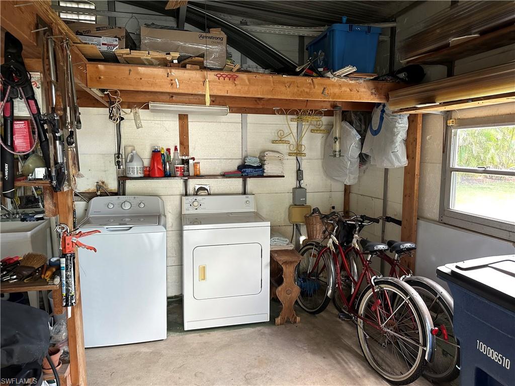 26212 Colony Road Bonita Springs, FL 34135 - Photo 34 of 34 Laundry room with washer, dryer, sink, and storage.