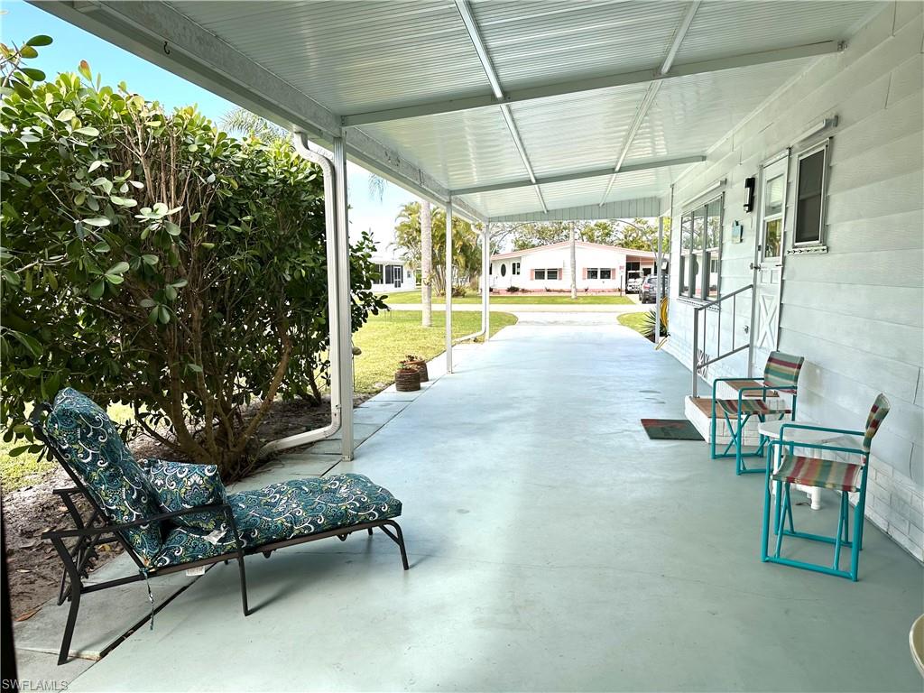 26212 Colony Road Bonita Springs, FL 34135 - Photo 5 of 34 Long carport lined with Clusia.
