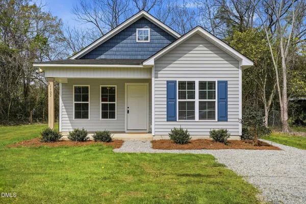 a front view of a house with a yard and outdoor seating
