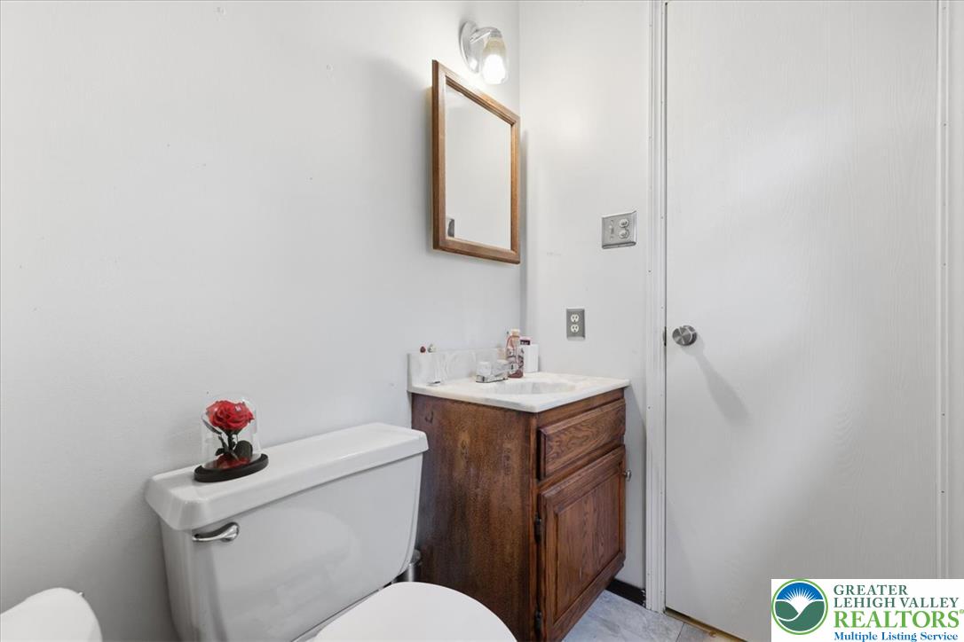 520 Highland Hill Road Jim Thorpe, PA 18235 - Photo 33 of 83 Functional full bathroom with a spacious vanity, toilet, and simple mirror.