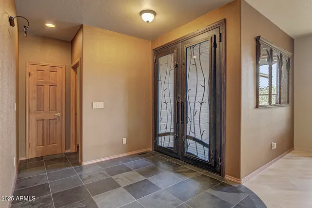 a view of a hallway with wooden floor and a bathroom