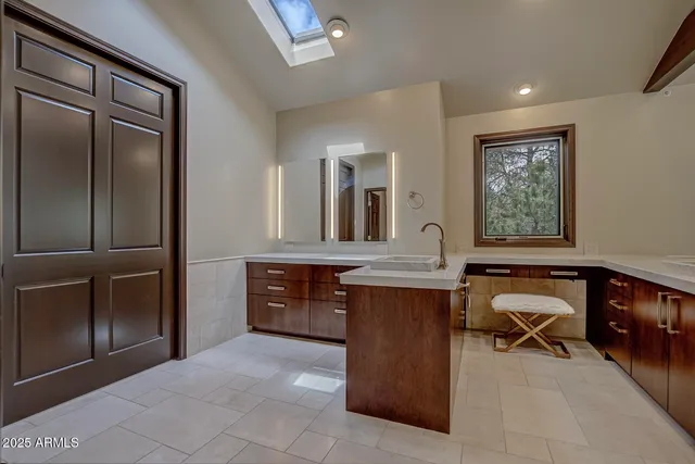 a bathroom with a granite countertop toilet sink and mirror