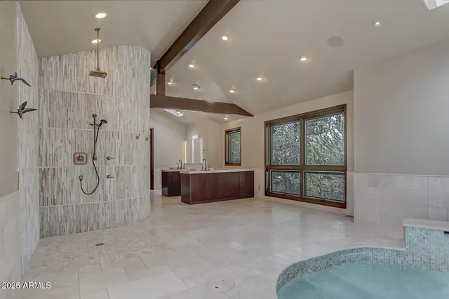 a bedroom with a large bed and a window