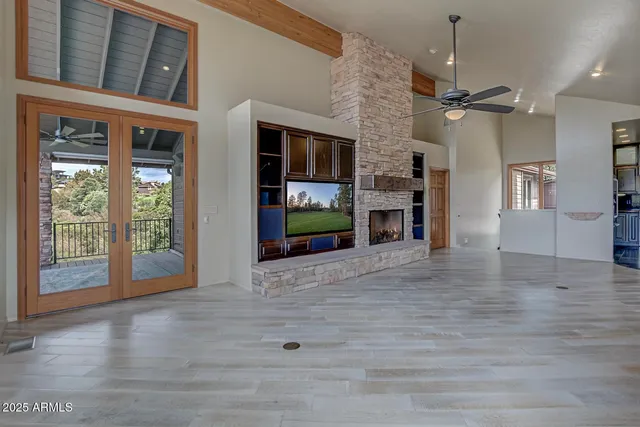 a kitchen with stainless steel appliances granite countertop a refrigerator a sink dishwasher a stove and a microwave oven with wooden floor