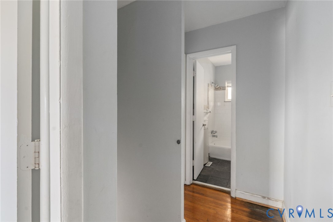 3109 North Parham Road, Unit 17 Henrico, VA 23294 - Photo 14 of 22 a bathroom with a walk in closet and a wooden floor