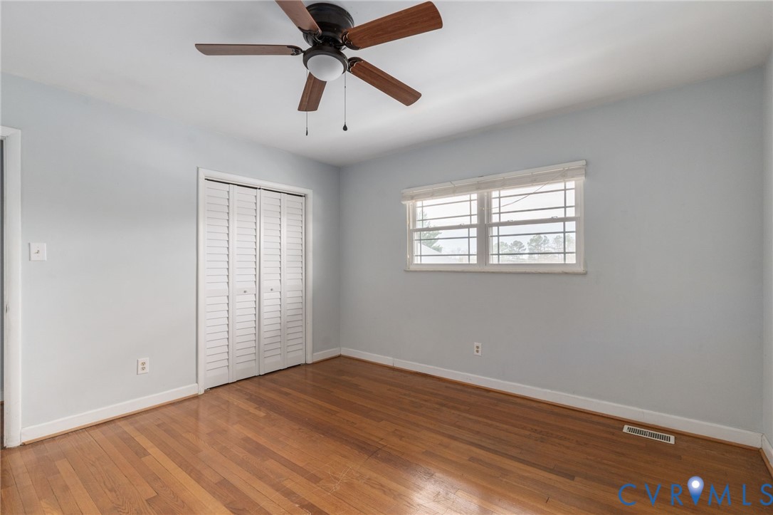 3109 North Parham Road, Unit 17 Henrico, VA 23294 - Photo 21 of 22 an empty room with wooden floor fan and windows