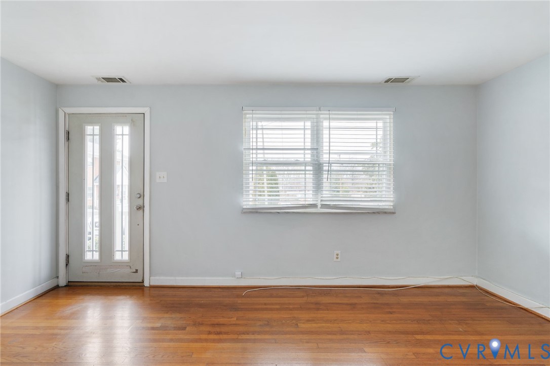 3109 North Parham Road, Unit 17 Henrico, VA 23294 - Photo 5 of 22 an empty room with wooden floor and windows