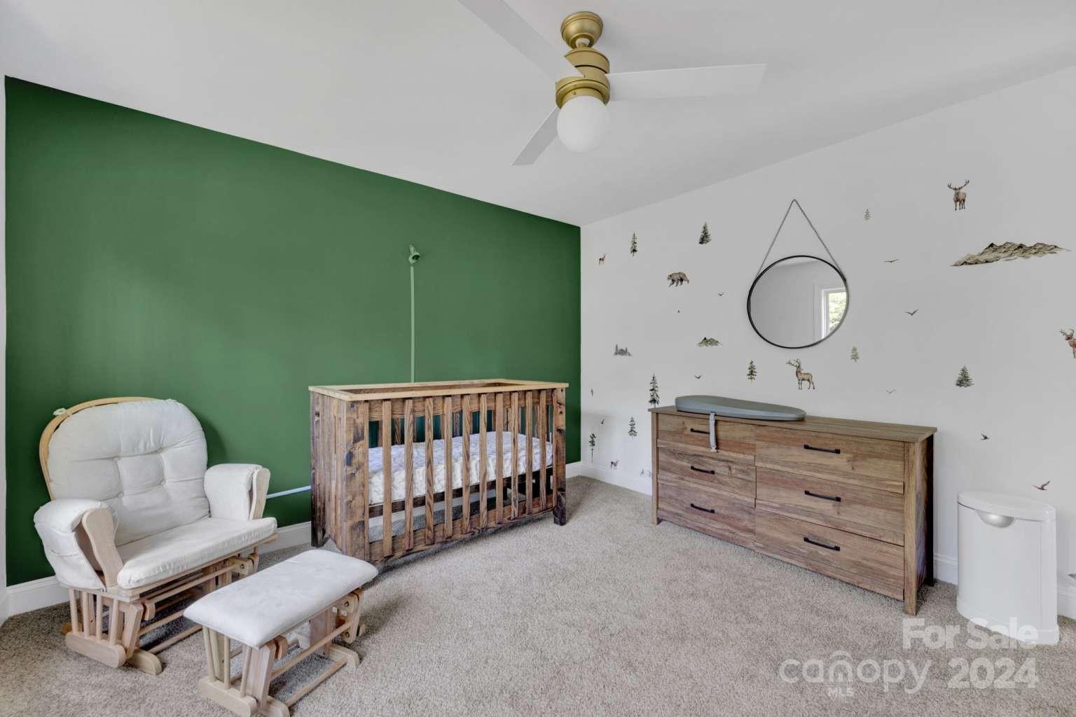 503 Arrow Point Lane Kannapolis, NC 28036 - Photo 18 of 23 a bedroom with a baby bed a couch and a chandelier