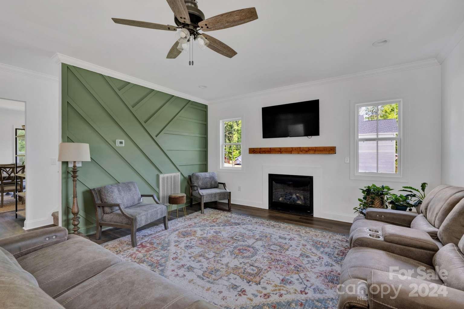 503 Arrow Point Lane Kannapolis, NC 28036 - Photo 4 of 23 a living room with furniture a fireplace and a flat screen tv