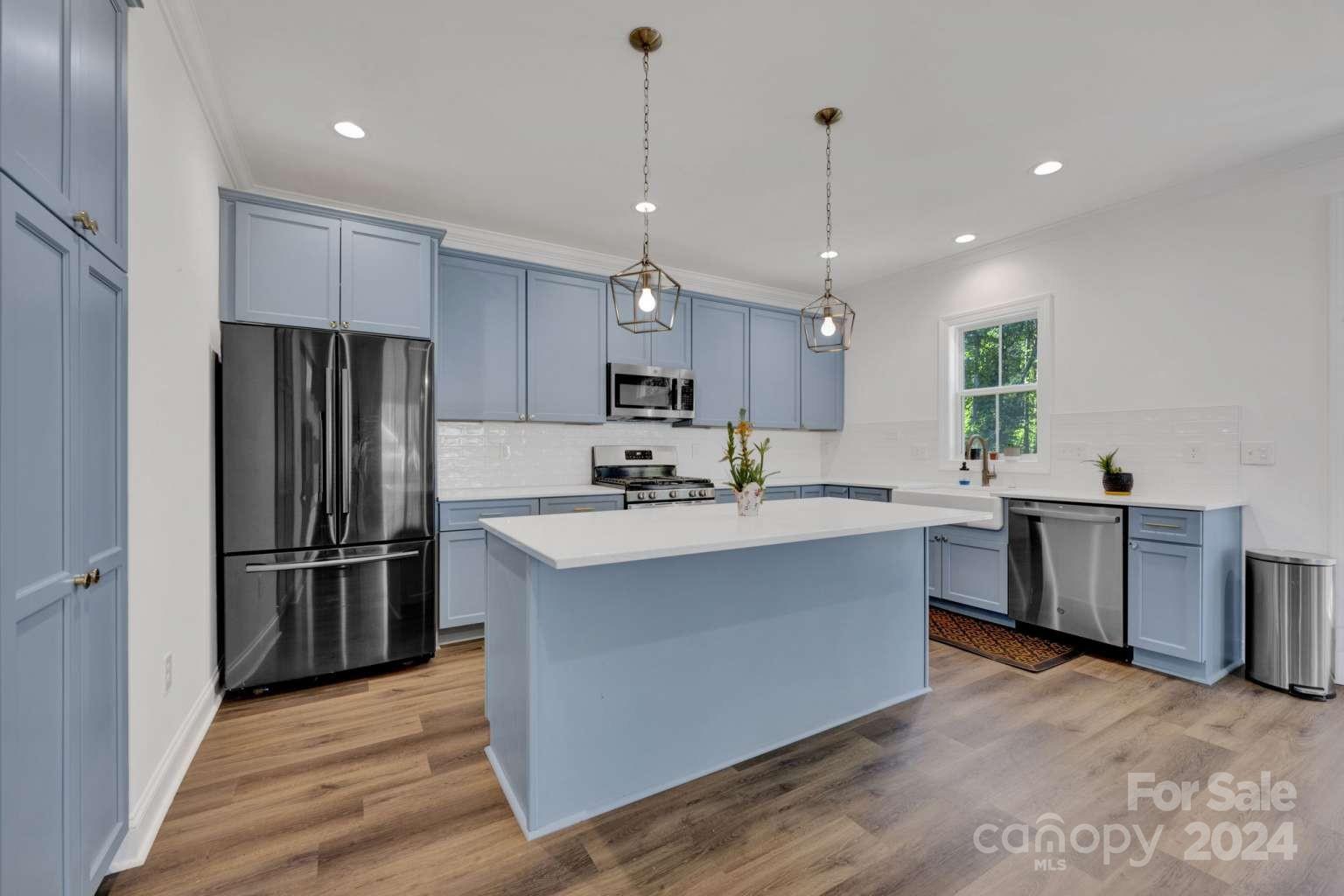 503 Arrow Point Lane Kannapolis, NC 28036 - Photo 6 of 23 a kitchen with kitchen island granite countertop wooden floors stainless steel appliances a sink and a center island