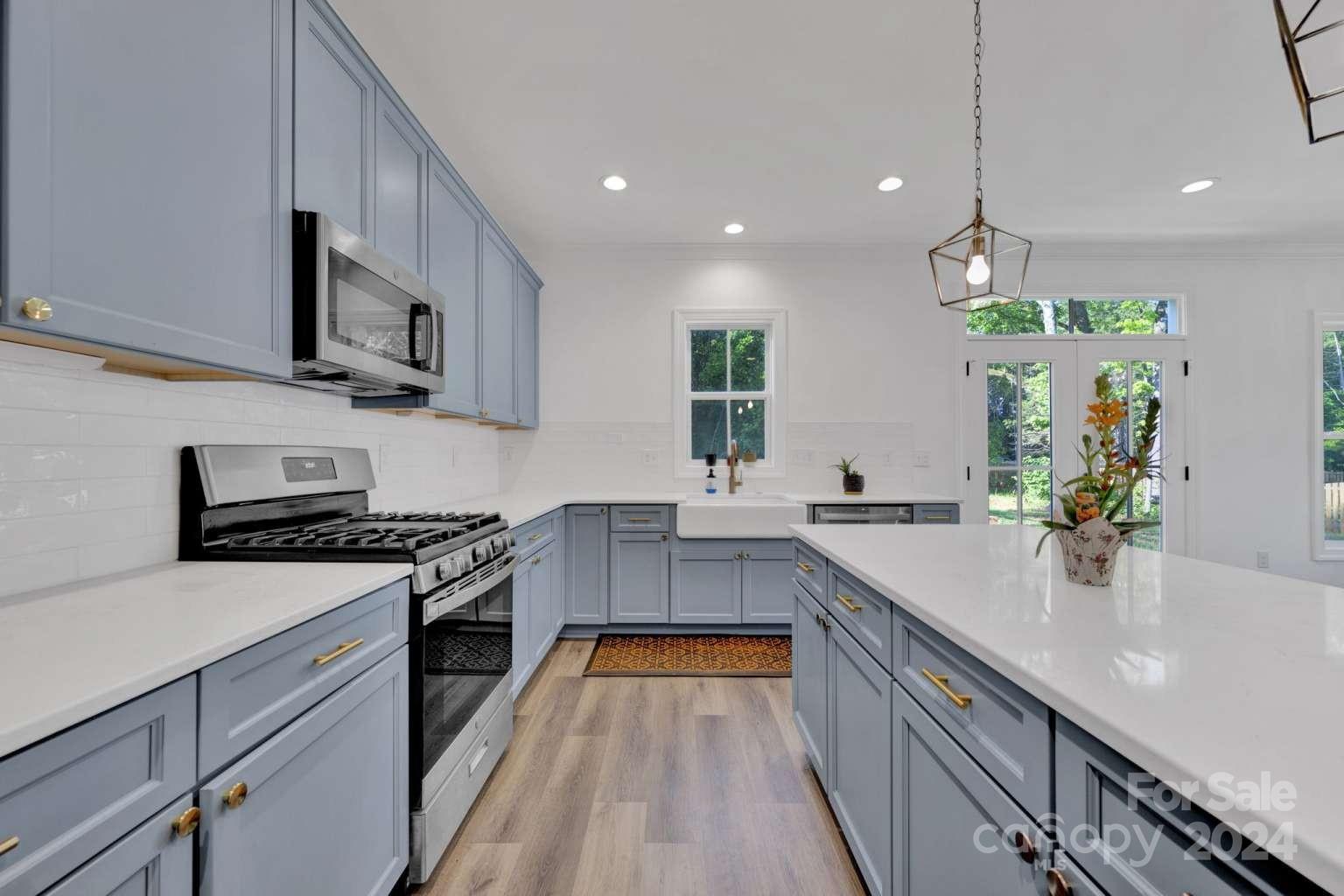 503 Arrow Point Lane Kannapolis, NC 28036 - Photo 7 of 23 a kitchen with stainless steel appliances a sink dishwasher a stove top oven a refrigerator with wooden floors