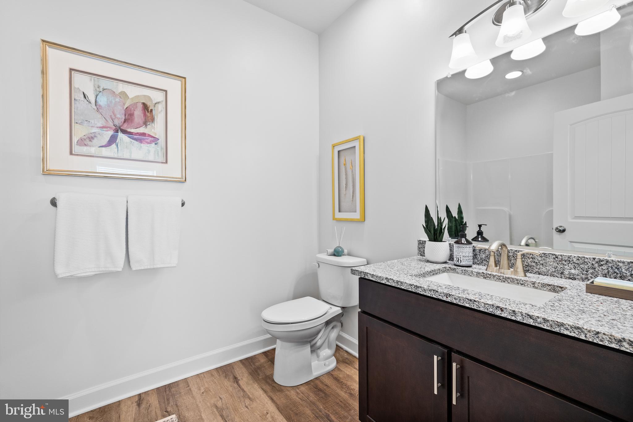 170 Cambridge Boulevard Freedom, PA 15042 - Photo 11 of 19 a bathroom with a granite countertop sink a toilet and a mirror