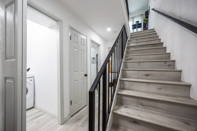 a view of entryway and hall with wooden floor