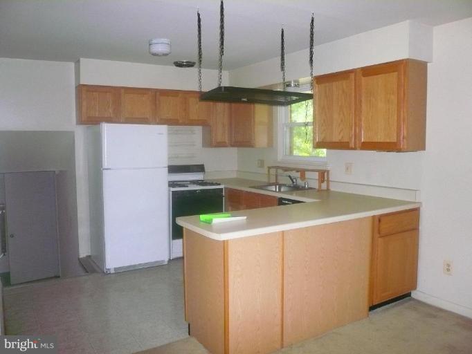 5944 Atteentee Road Springfield, VA 22150 - Photo 2 of 7 a kitchen with a sink a stove and a window