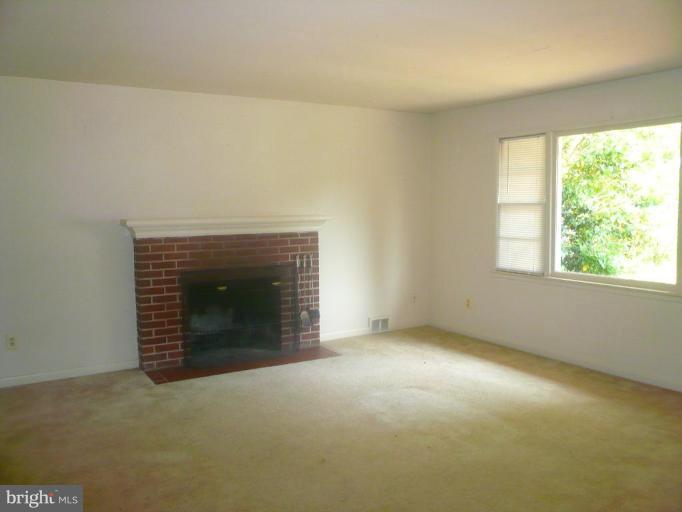 5944 Atteentee Road Springfield, VA 22150 - Photo 3 of 7 an empty room with a fireplace