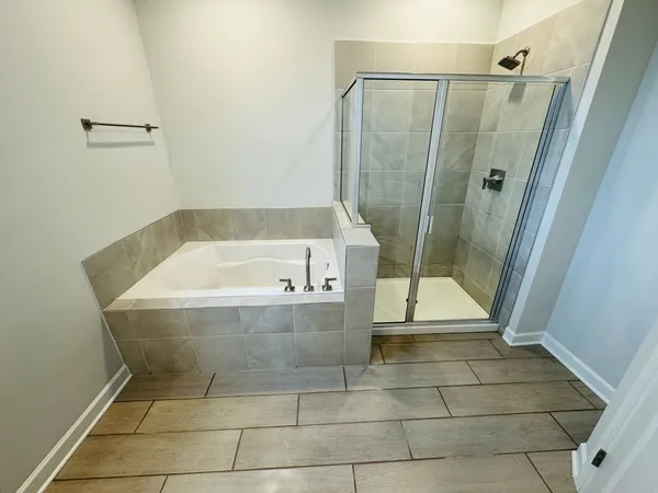 a bathroom with a bathtub and shower