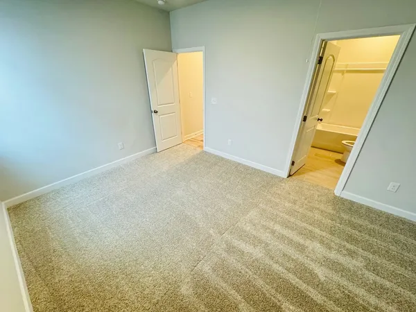 a bathroom with a sink a toilet a mirror and shower