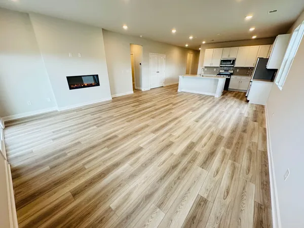 a large room with kitchen view and living room view