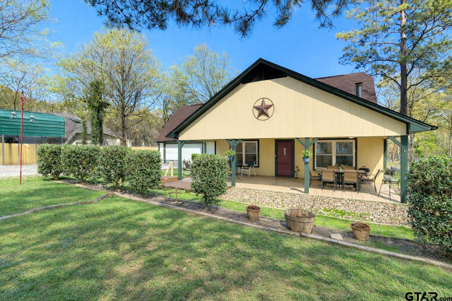 a front view of a house with yard and green space